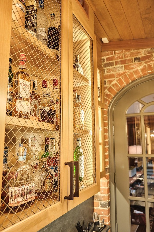 buckhead bar brass mesh lining of upper liquor cabinets