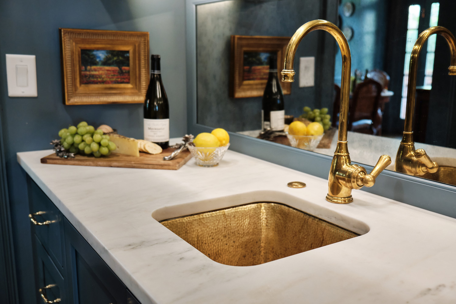 detail of the hammered brass sink and brass faucet in the custom bar area