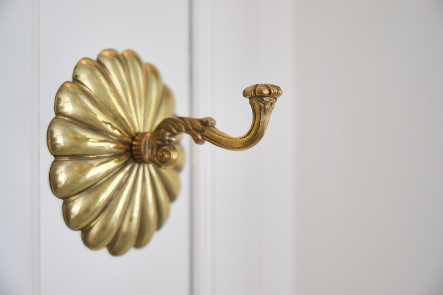 a flowered brass towel hook