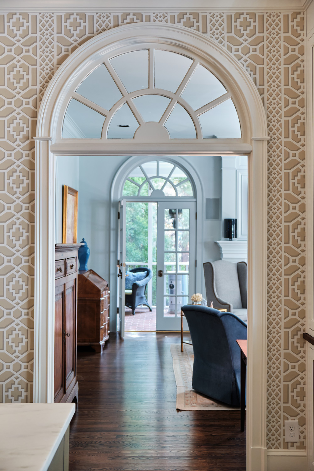 an original arch with transom looking into the living room from the kitchen