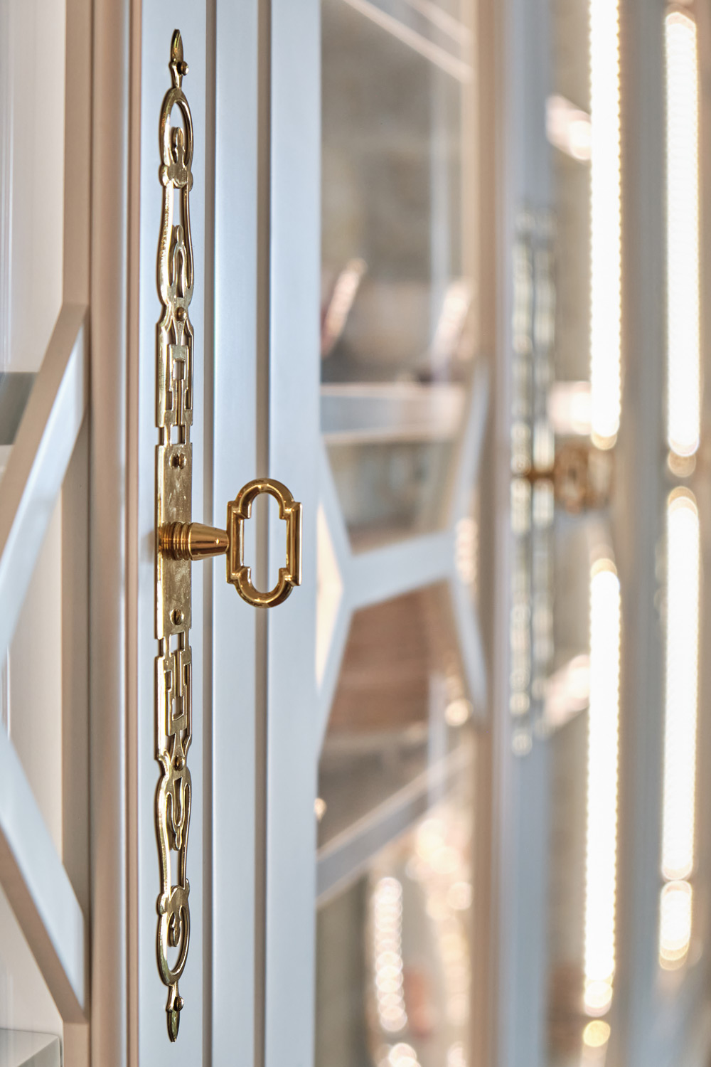 ornate custom gold hardware on the hutch glass doors