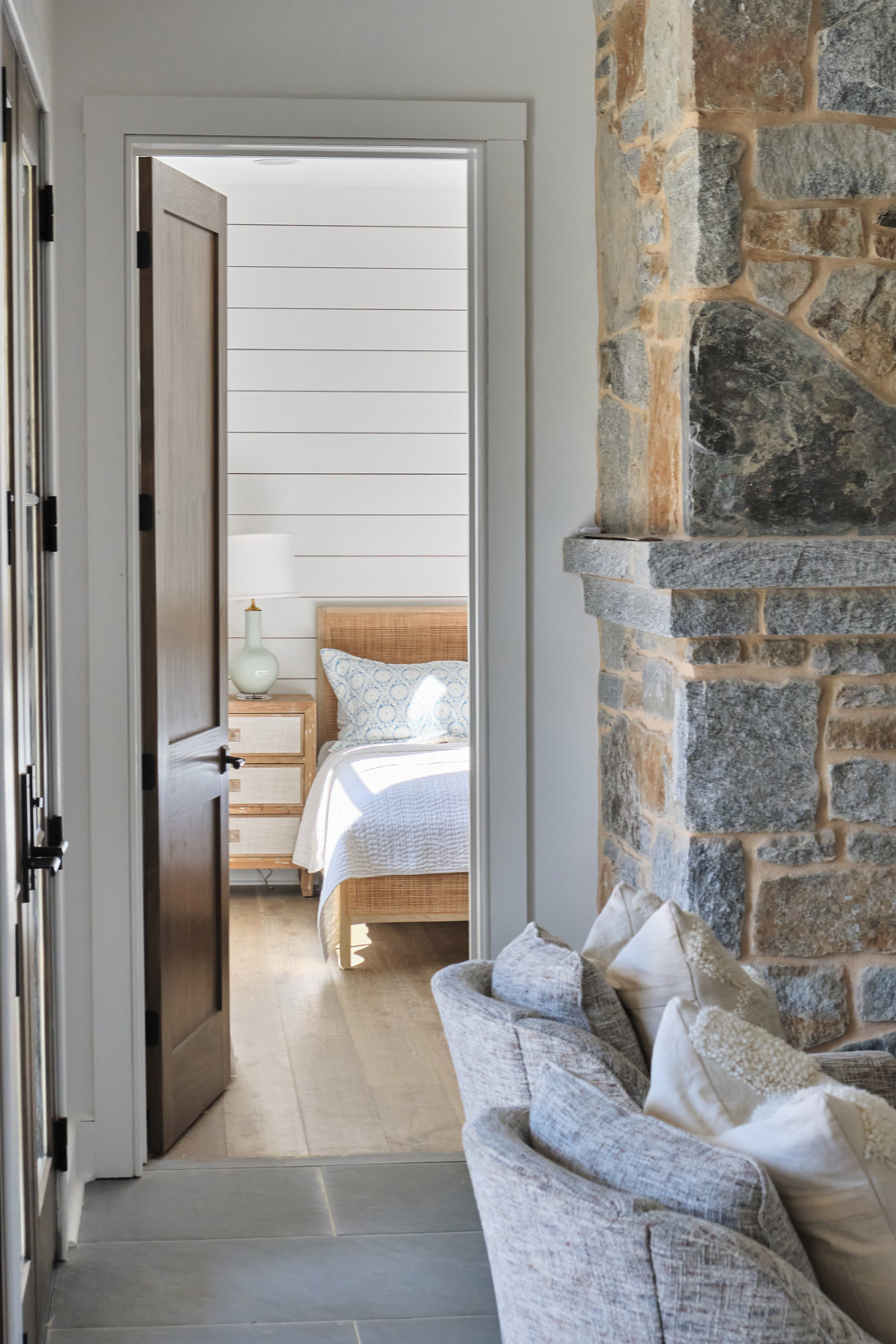 a peek into the downstairs bedroom next to the stone fireplace