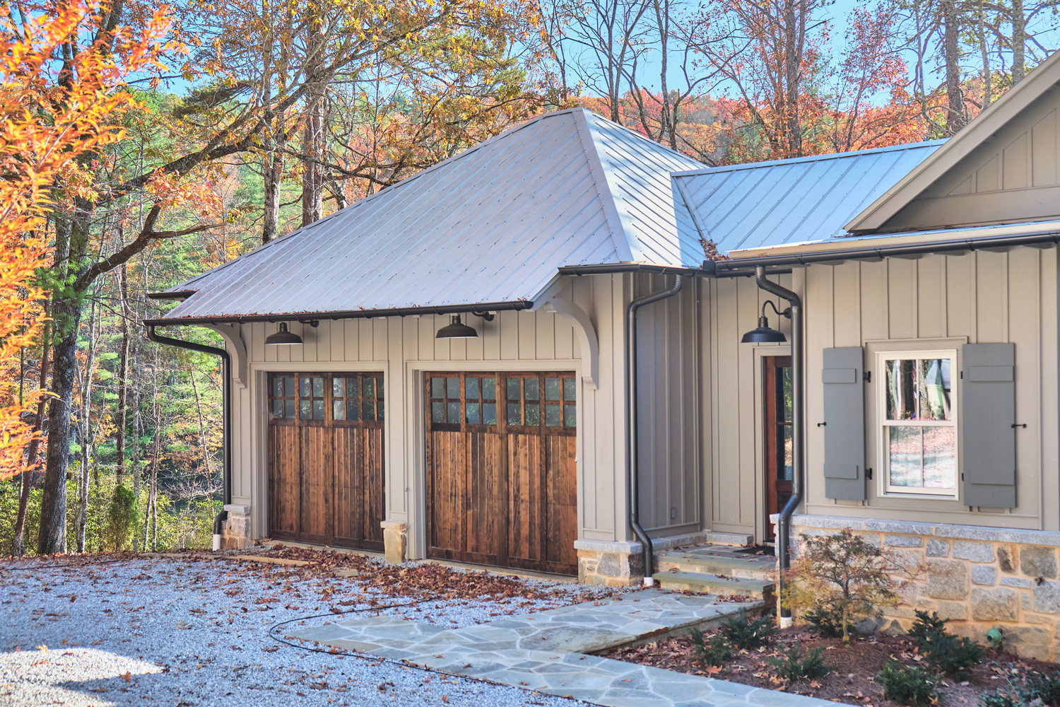 stained pecan wood garage doors on the exterior of the house