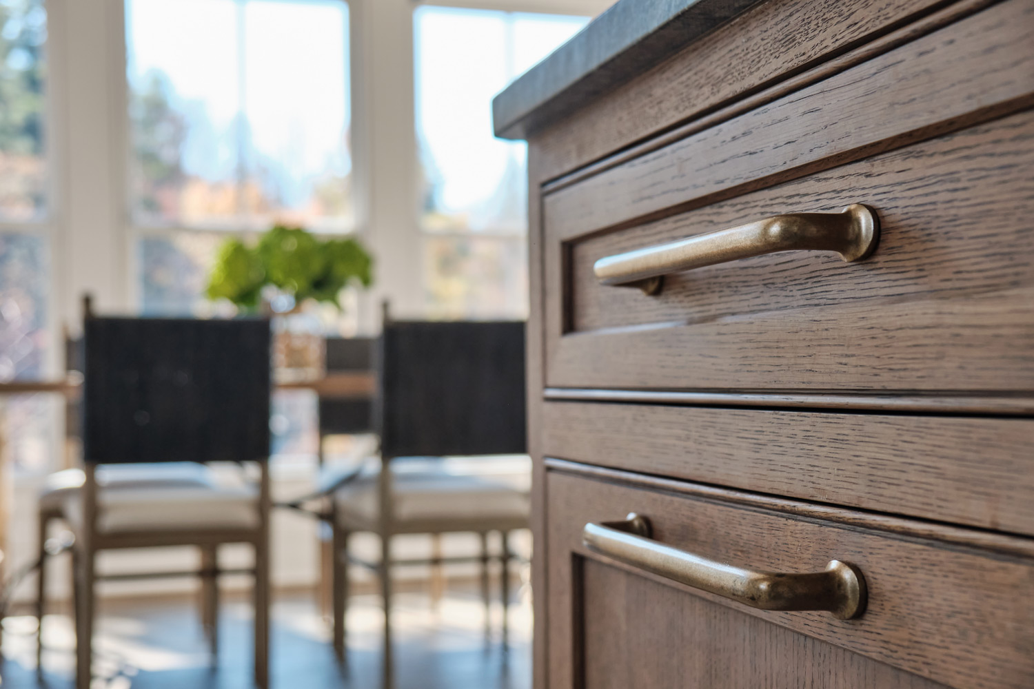 brass cabinetry detail on the natural wood cabinets in the kitchen