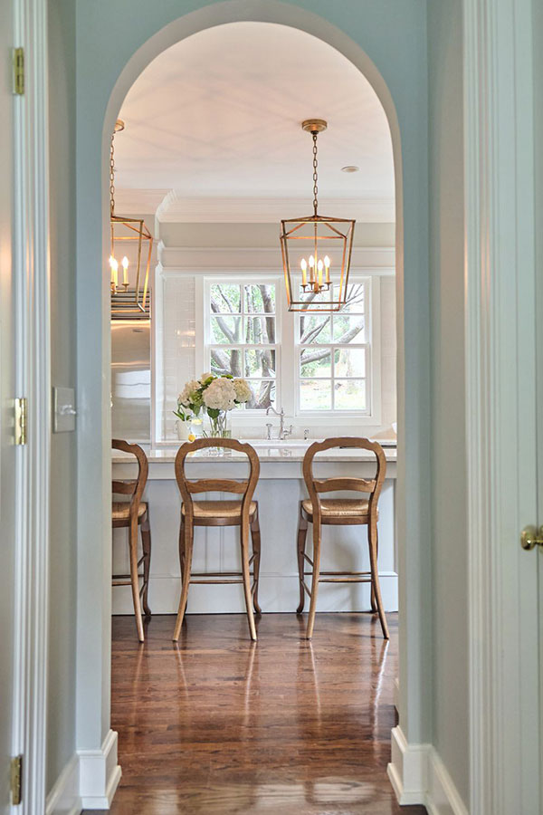 english country kitchen island viewed through hallway arch