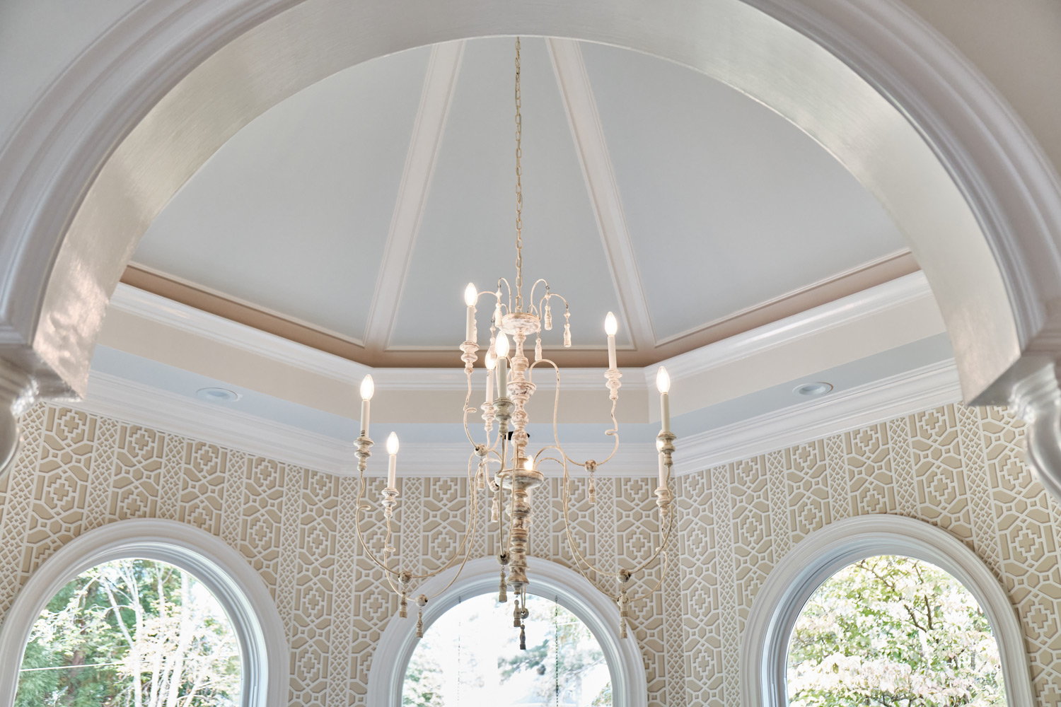 the light blue ceiling and patterned wallpaper in the breakfast room