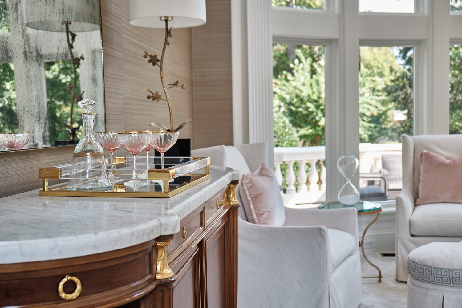 two story windows open up on to this seating nook in the living room