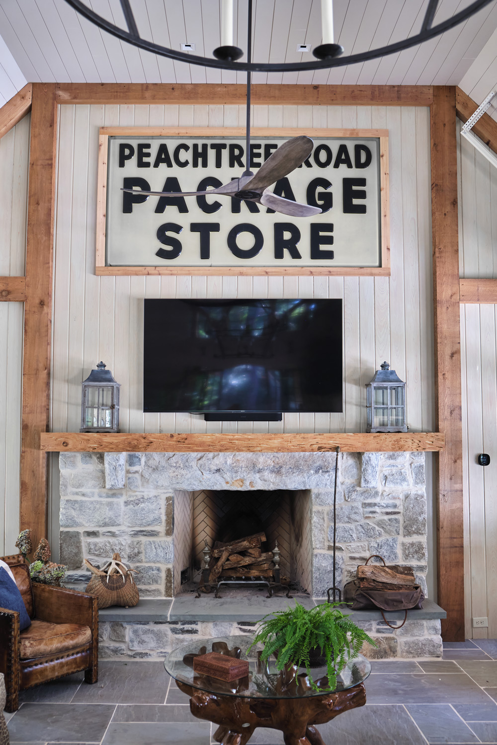a wide view of the stone fireplace with wood beam detail